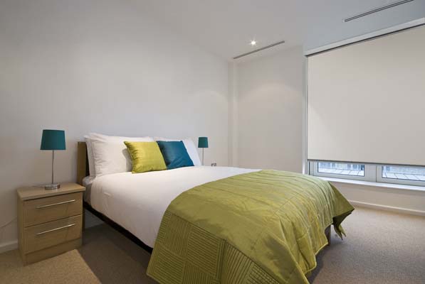Light weight blockout blinds in a bedroom in Brisbane